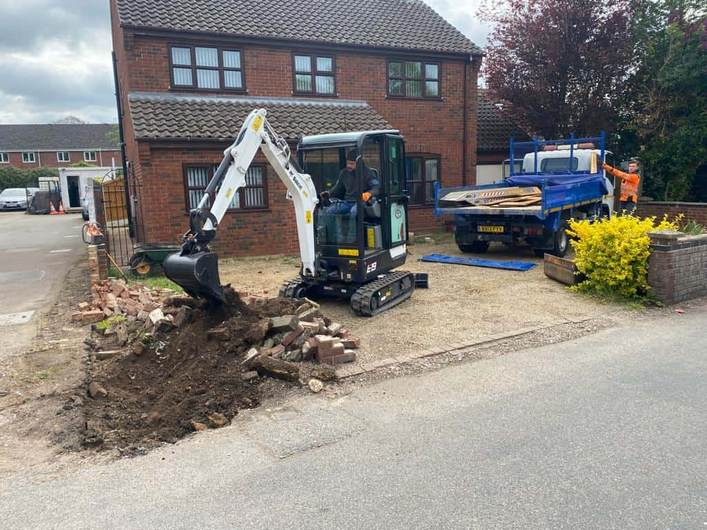 This is a photo of an operative of NS Driveways Chertsey Digging out for a new tarmac driveway